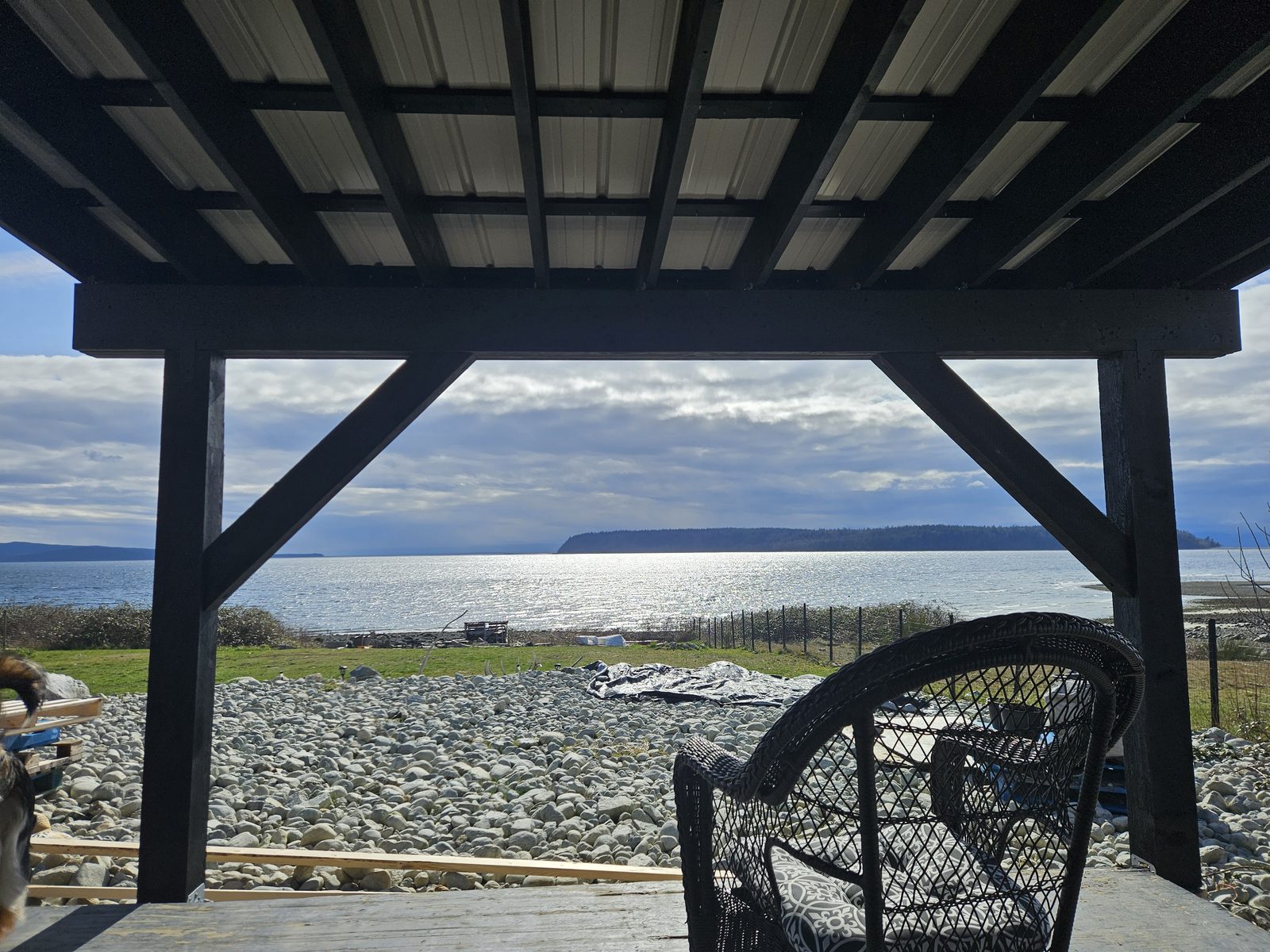 A post and beam deck cover with black-stained timbers at Tla'amin Nation