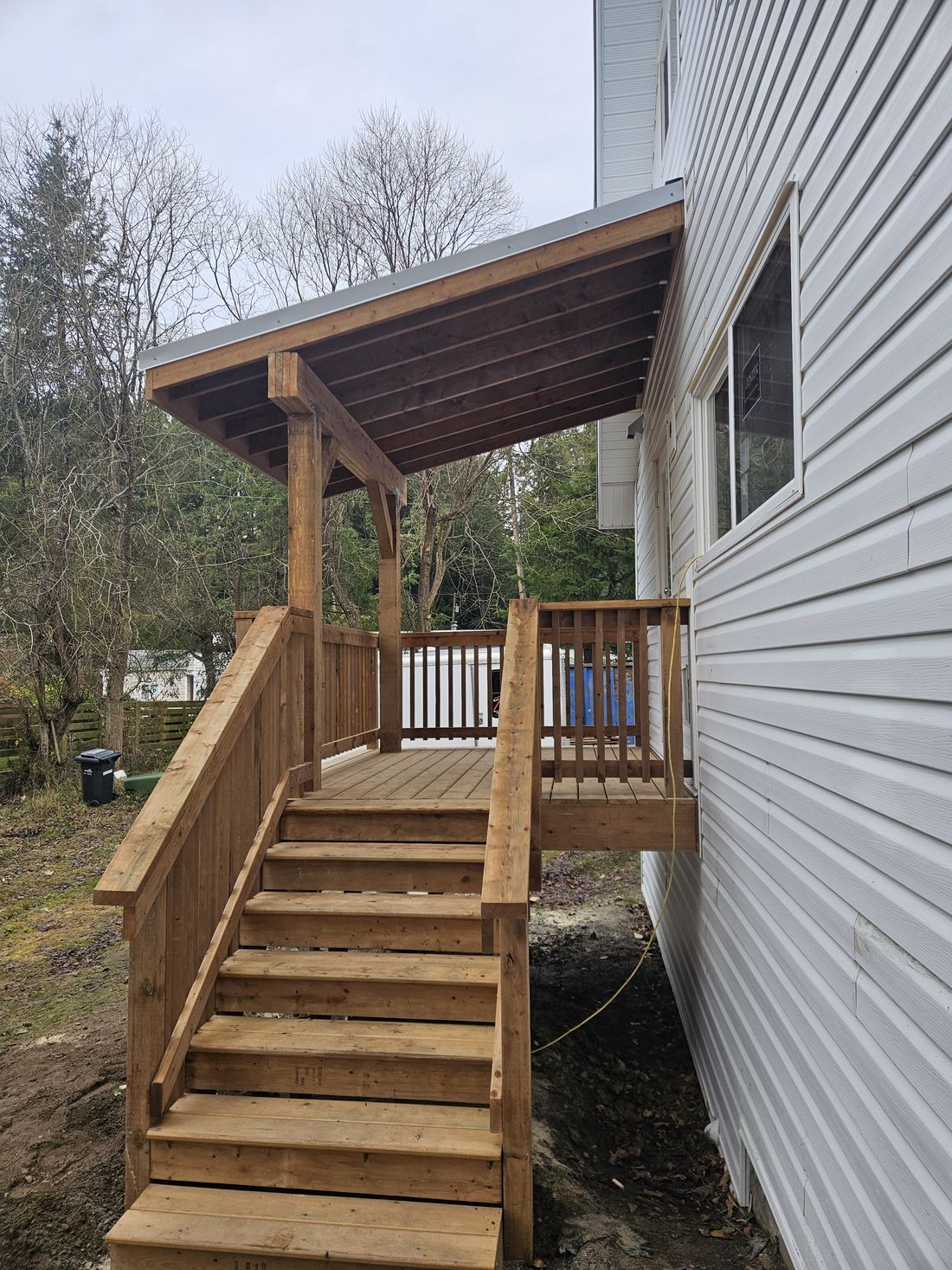 A covered entry deck and stair on a rebuilt 1930s house