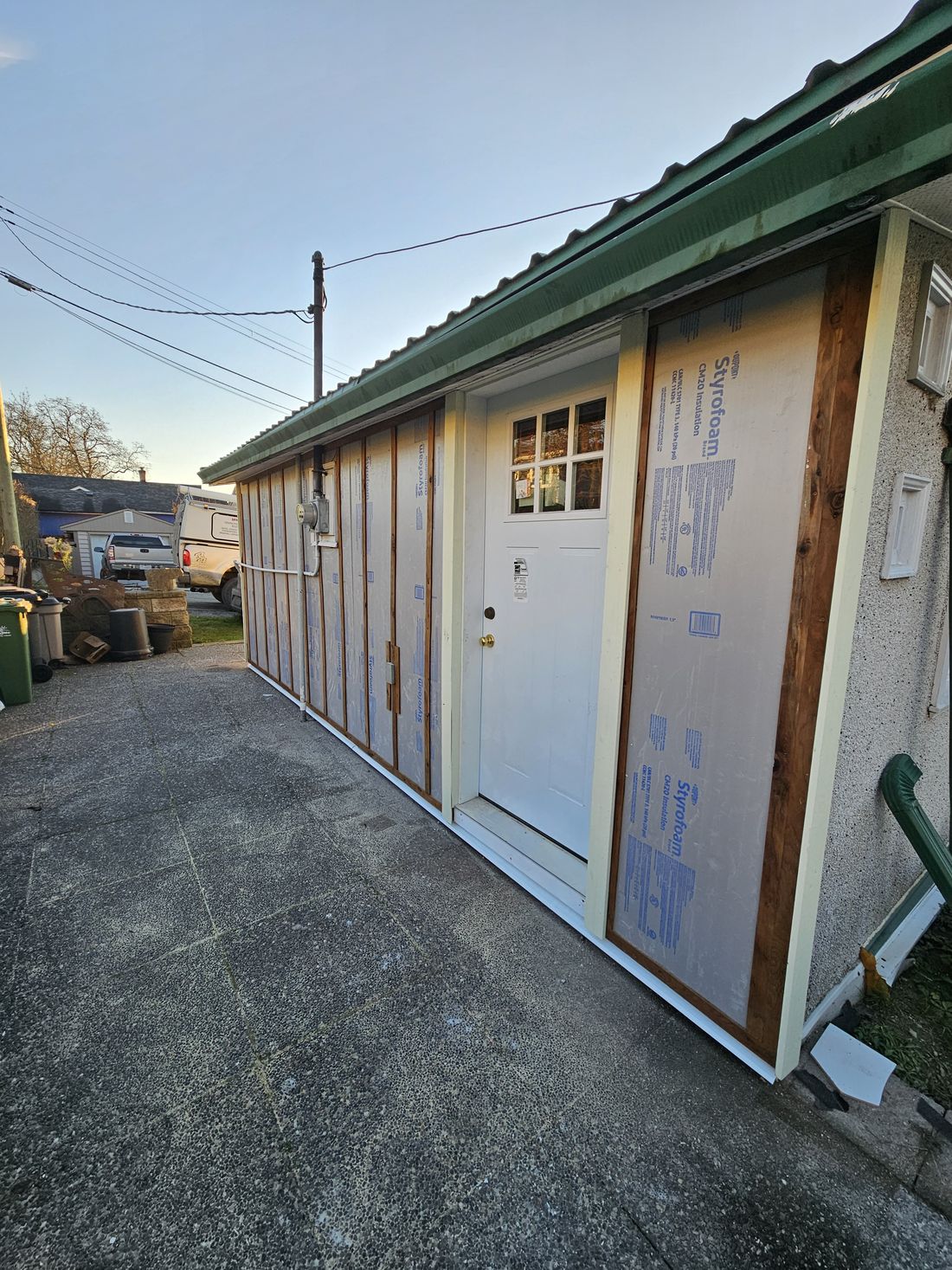 Rigid insulation and a new door on a wall rebuilt after a car struck the house