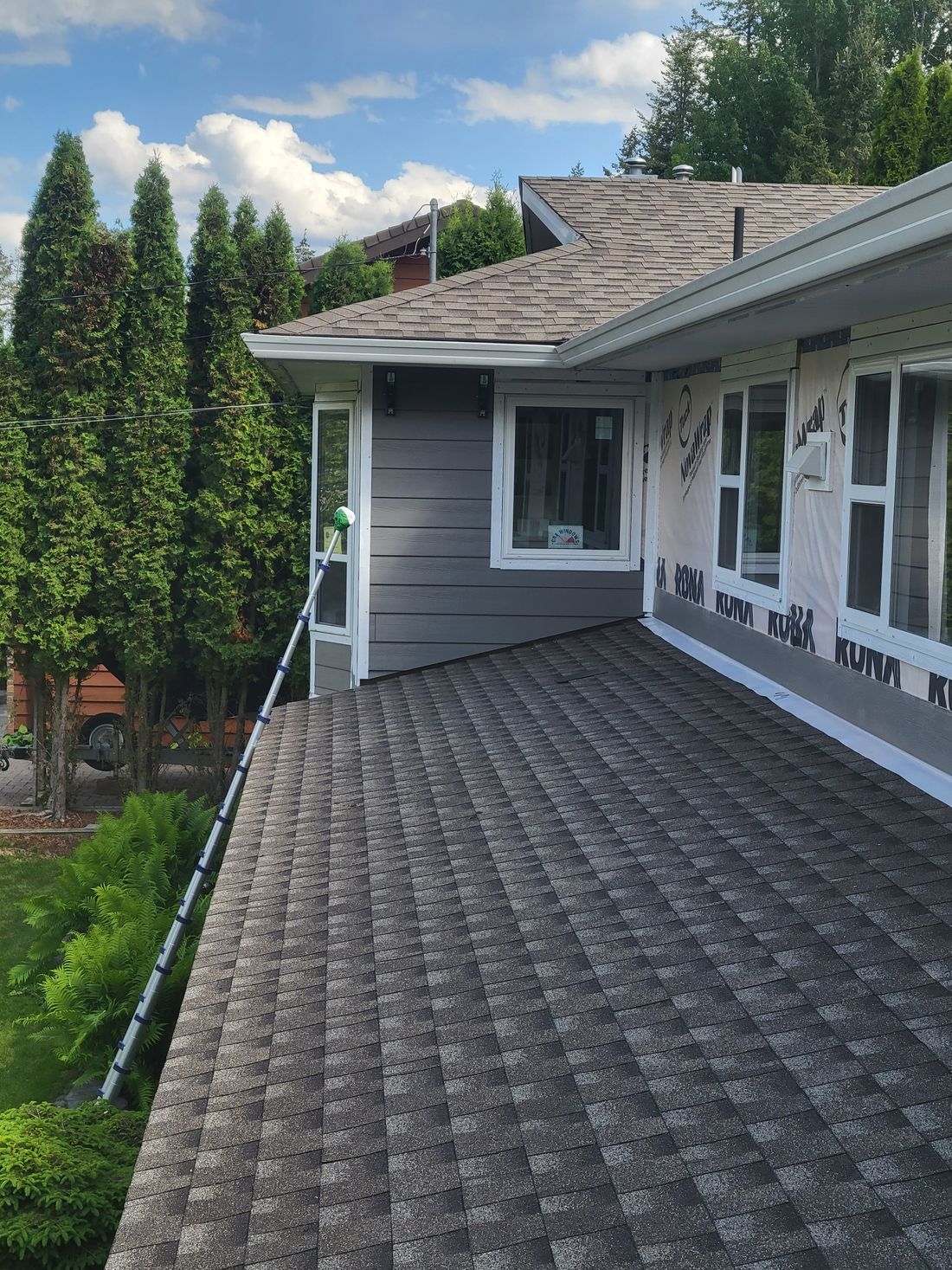 Hardie board going on over new building wrap in Williams Lake