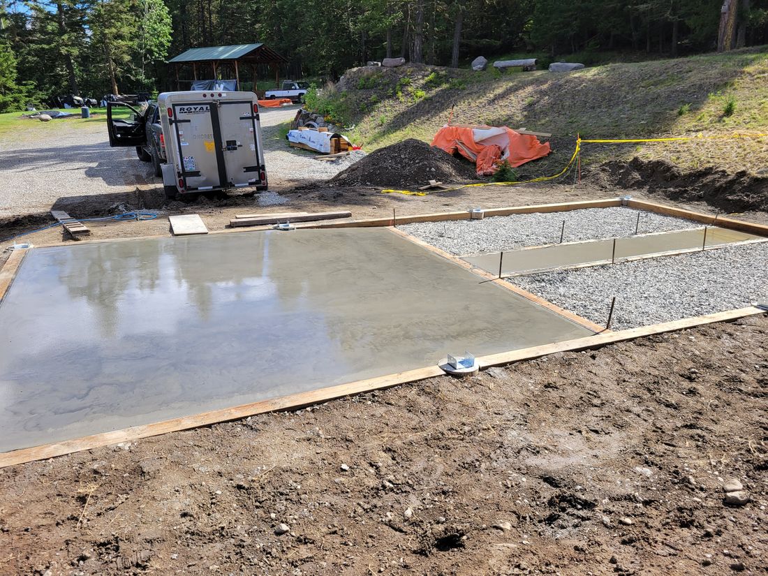 A poured slab and formed walkway with post saddles set