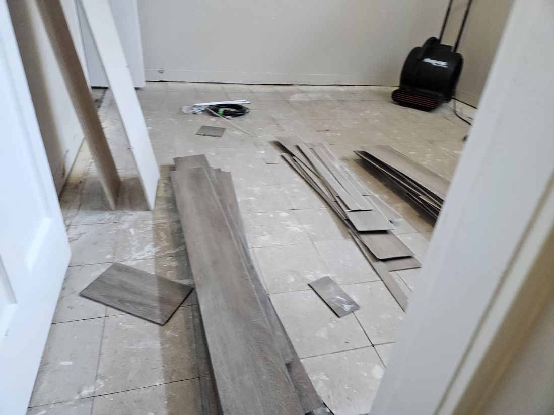 Vinyl plank lifted with an air mover running