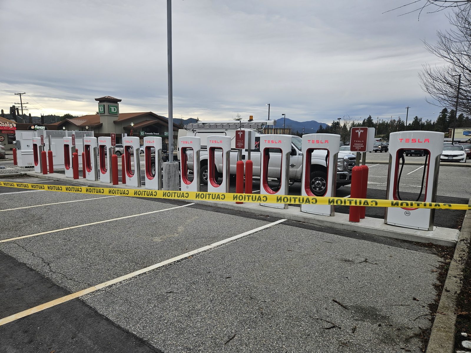Tesla Supercharger stalls taped off during province-wide bollard removal
