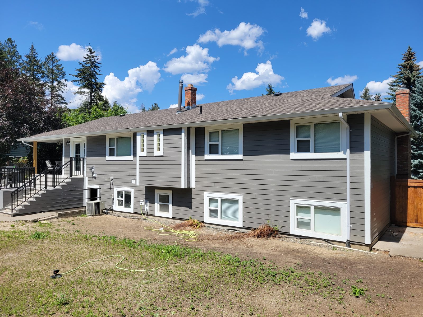 The back of a Williams Lake home re-sided in Hardie board over new building wrap